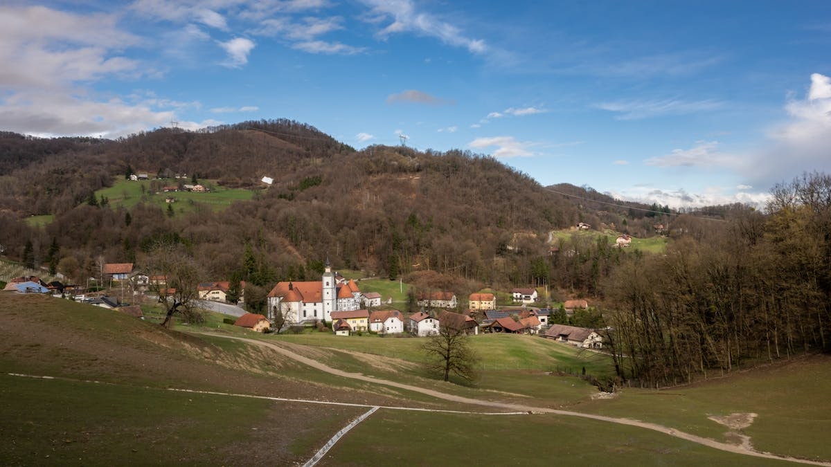 Picturesque village landscape in Šmarje pri Jelšah, Slovenia surrounded by rolling hills during springtime.